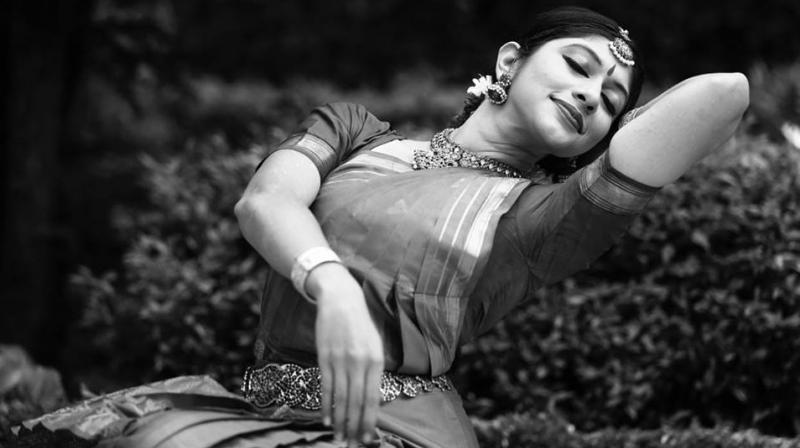 An expressive black-and-white dance portrait of Dakshina